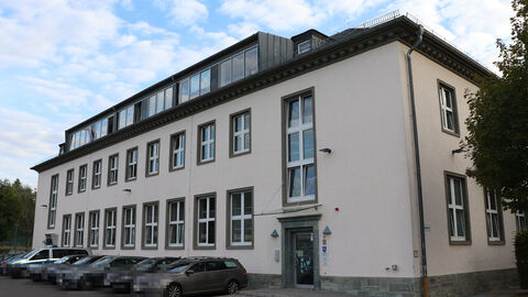 Weißes zweistöckiges Gebäude mit Fensterfront