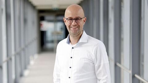 Polizist in weißem Hemd in einem langen Glasdurchgang